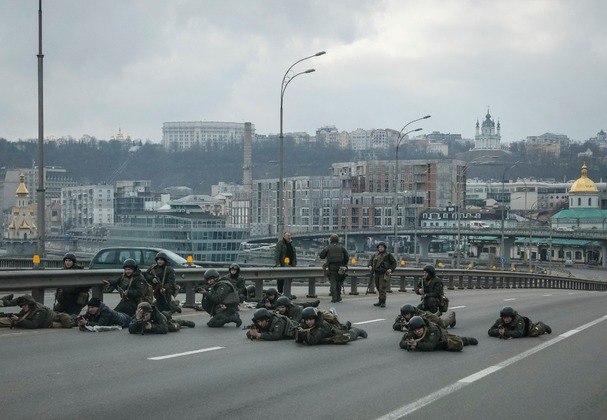 Homens da Guarda Nacional se posicionam em uma ponte que dá acesso ao centro da capital ucraniana  